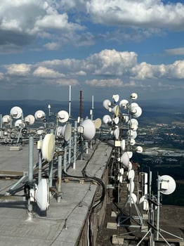Radio transmitting center with many Radio link Stations microwave is located in peak mountains, with beautiful aerial view. Telecommunications tower inspection for cell phone, radio transmitters. photo