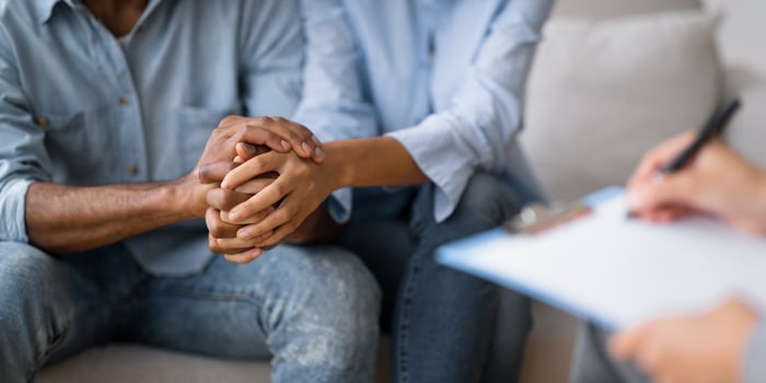 Couples Therapy Concept. Unrecognizable Black Man And Woman Holding Hands At Marital Psychologist's Office. Cropped, Selective Focus photo