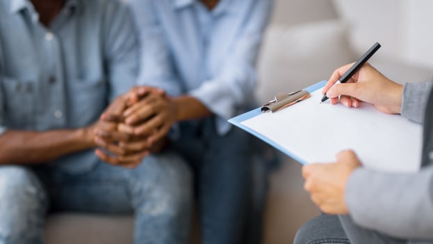 Professional Couples Therapy. Unrecognizable Afro Spouses Holding Hands Visiting Marital Counselor. Selective Focus, Cropped photo