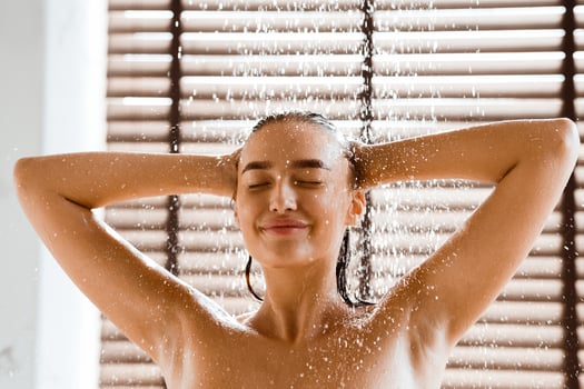 Enjoy Cool Shower. Woman Washing Long Hair Under Water Jet photo