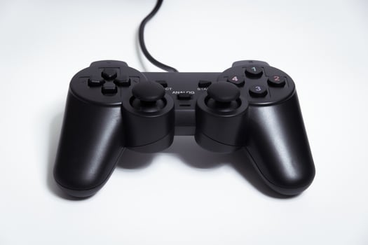 Black controller on white background, game device, Joystick on a white background. photo