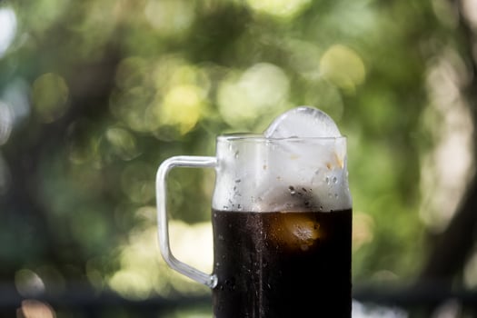 Iced black coffee in a glass with a handle photo