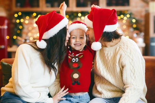 Love, family, kids, New Year, Christmas concept. Festive parents kissing happy little girl, celebrating Christmas together photo