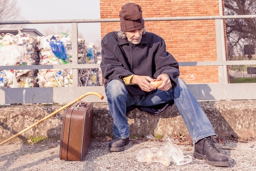 tramp eating bread sitting in landfills photo