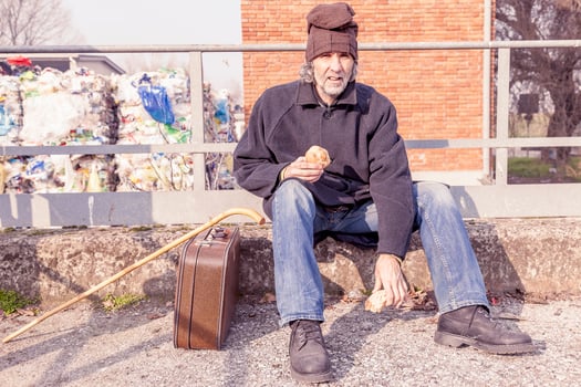 tramp eating bread sitting in landfills photo