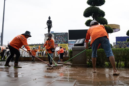 Chiang Rai, Thailand - 13-September-2024 - Workers while cleaning muddy floor at King Meng Rai monument after water flooding from Typhoon Yagi. photo