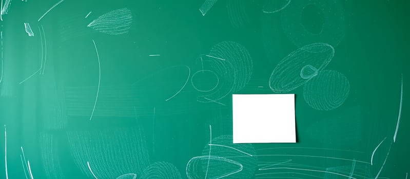 Blank white note on green chalkboard photo