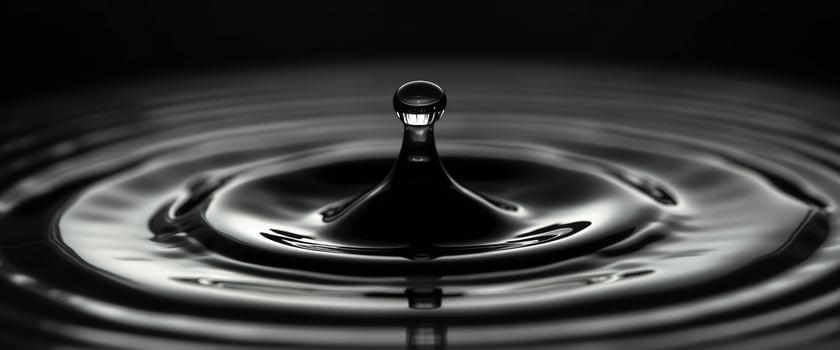 Water Drop Ripples on Black Surface photo