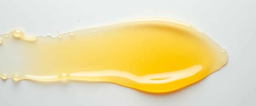 Golden Liquid Droplet on White Background photo