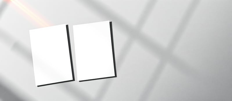 Two Blank Cards Mockup on a White Wall with Window Light photo