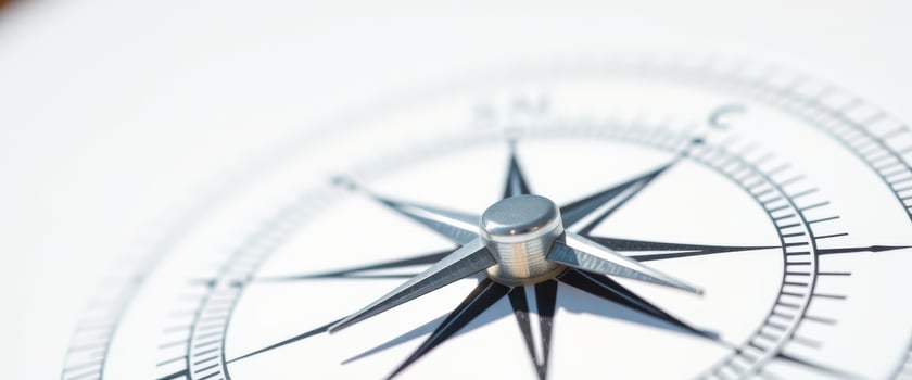 Closeup of a compass needle pointing north photo