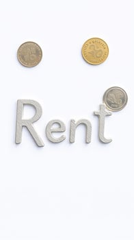 Metal Letters Rent and Coins on White Background photo