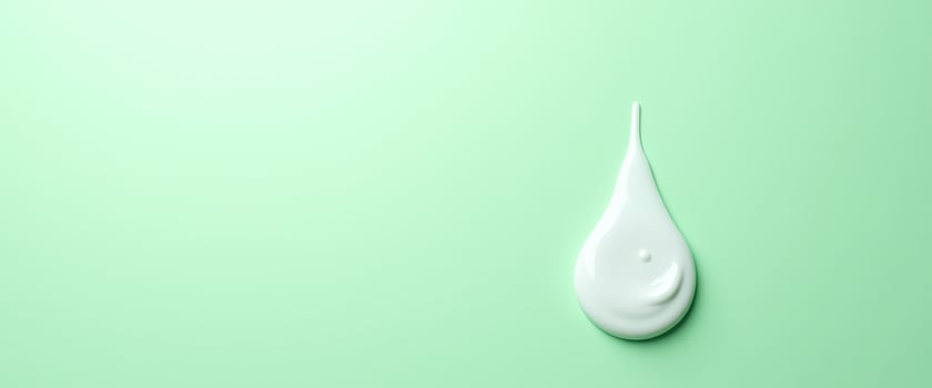 Drop of Cream on Green Background photo