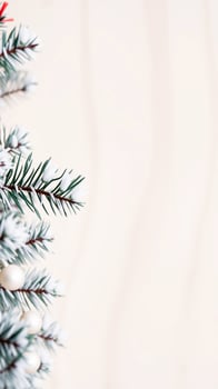Snowy Christmas Tree Branch with White Ornaments photo