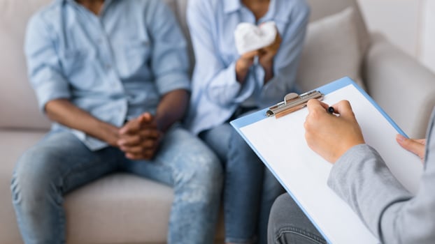 Therapy session concept. Couples psychologist counselling frustrated african american spouses in office. Shallow depth, selective focus, cropped photo