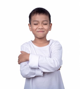 Portrait of asian boy wearing a white shirt posing showing happiness isolated on white background. photo