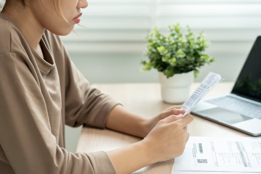 Stressed and headache woman with large bills or invoices no money to pay to expenses and credit card debt. shortage, Financial problem, bankruptcy, mortgage, loan, bankrupt, poor, empty wallet photo