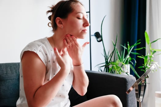 Young girl applies moisturizing cream to her neck skin. Self-massage. Home skin care concept. photo