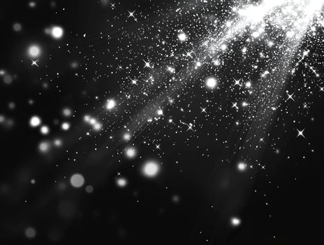 Small silver dots scatter chaotically across a dark background, some glowing brightly while others fade, creating a mesmerizing stardust effect reminiscent of the cosmos. photo