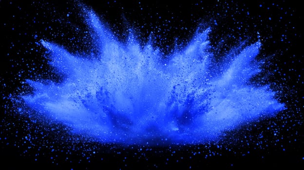 Vibrant blue particles burst forth in a stunning explosion, glowing brightly as they radiate into space, dispersing into fine, shimmering dust amidst a dark background. photo
