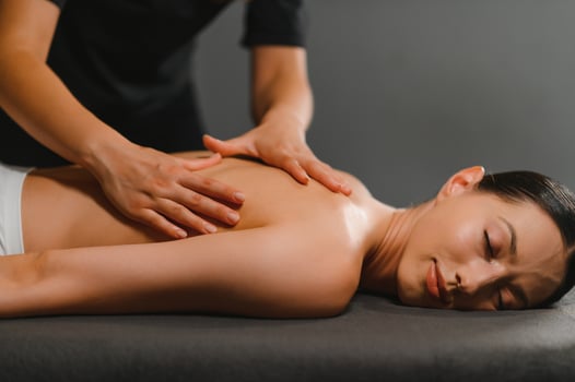 Masseur doing massage on woman back in the spa salon photo