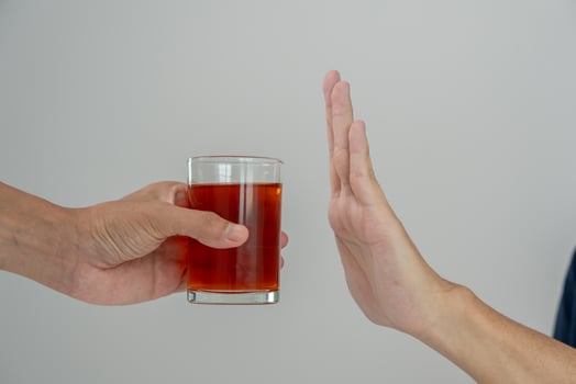 man refuses say no and avoid to drink an alcohol whiskey , stopping hand sign male, alcoholism treatment, alcohol addiction, quit booze, Stop Drinking Alcohol. Refuse Glass liquor, unhealthy, reject photo