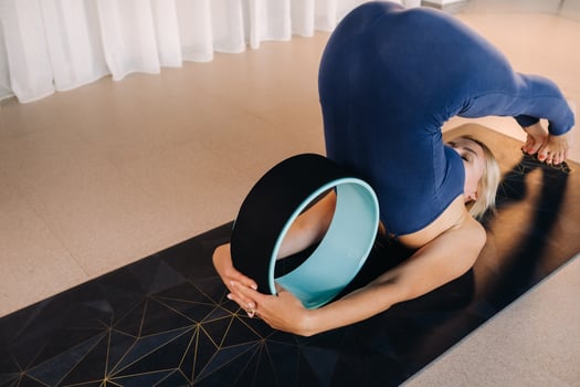 A woman does yoga with a Pilates ring, stretching the body, meditating training softness photo
