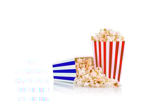 Glass with popcorn on a white background photo