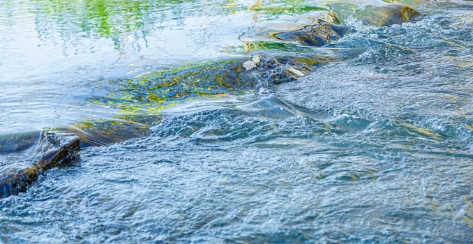 flow of water and spray from a stone photo