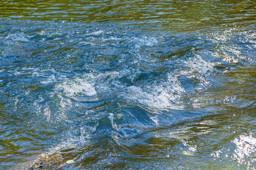 flow of water and spray from a stone photo