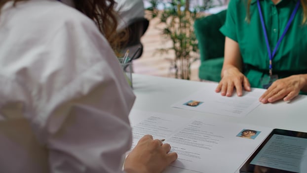 HR staff going through the selection process phase of the recruitment activity, choosing the best applicant based on their qualifications in the resume. Recruiters seeking talent. Camera B. photo