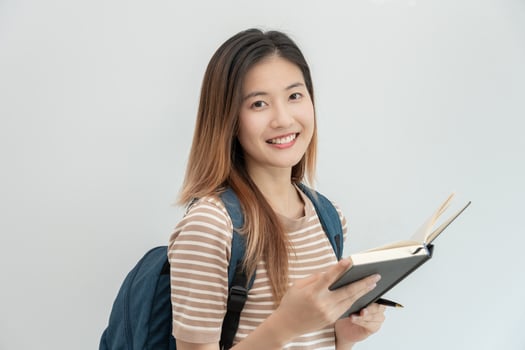 Portrait beautiful Asian woman student. Smile girl happy study. read book in college campus. young female on international Asia University. Education, study, school, learning, exam, continue education photo