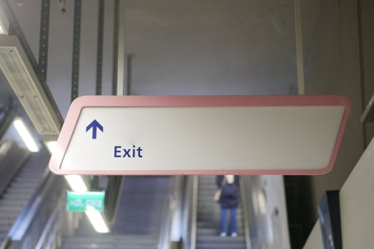 Directional Exit Sign prominently displayed in a Modern Transit Station for commuters photo
