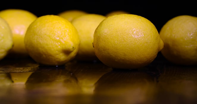 ripe lemon on a black background photo