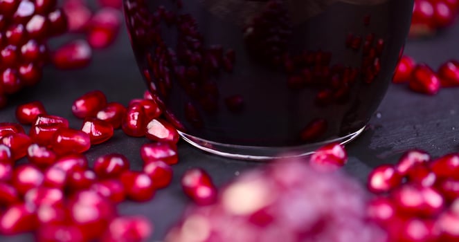 red grains of peeled pomegranate fruit, close up photo