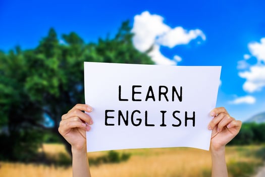 Learn english message written on white paper with nature background. Conceptual learn english symbol. Copy space. photo