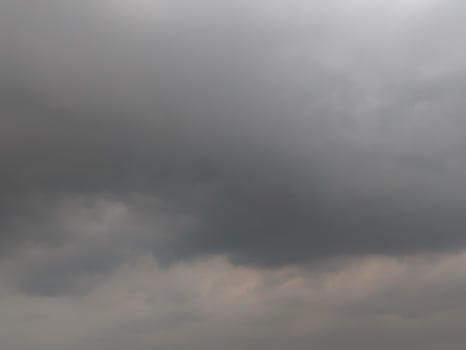 A moody, atmospheric sky filled with heavy, gray clouds. photo