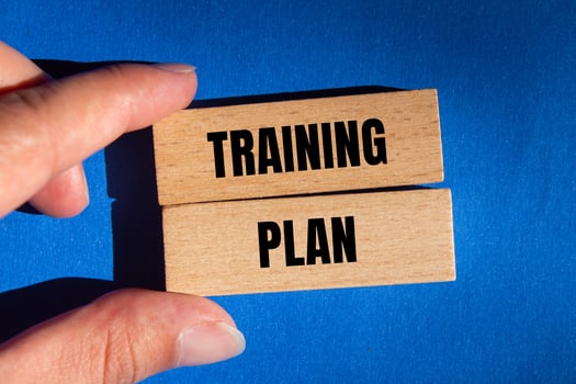 Training plan message written on wooden blocks with blue background. Conceptual training plan symbol. Copy space. photo