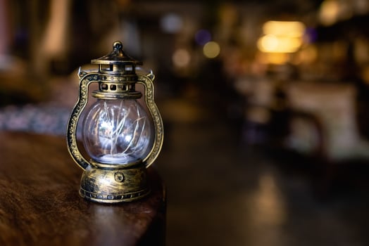 old vintage rusty kerosene black lamp isoleted on gray background. Glass oil lamp. photo