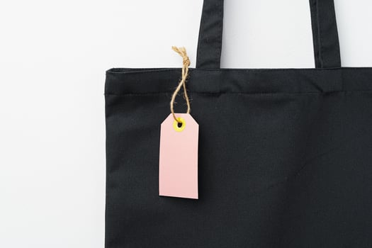 Eco bag for shopping with blank tag on white background photo