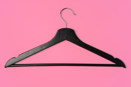 Flat lay composition with empty hangers on pink background photo