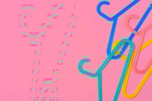 Flat lay composition with empty hangers on pink background photo