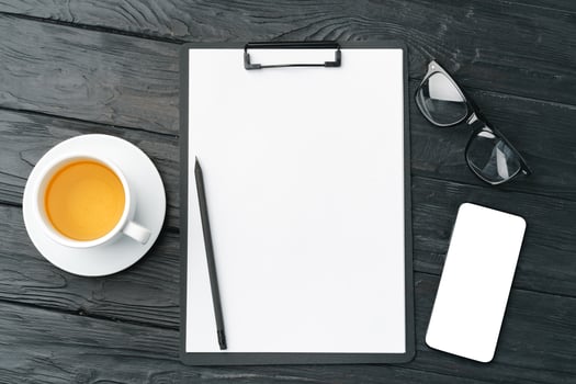 Blank paper on clipboard with space on dark gray background photo