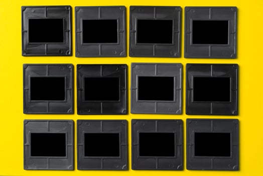 Photography empty slide frames on yellow background photo