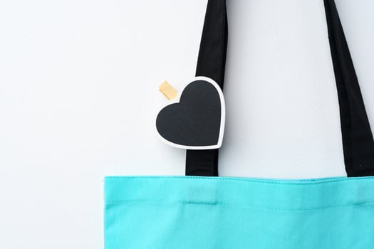 Cotton tote shopper bag with heart tag on white background photo