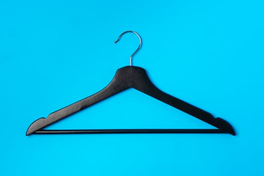 Blue hanger on trendy blue color background. Template fashion blog social media. photo