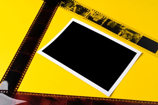 Old vintage film for a camera on yellow background photo