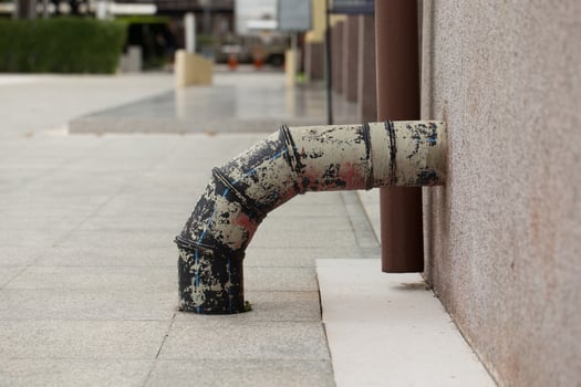 A paint-splattered pipe endures. photo