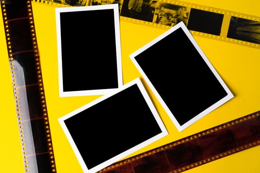 Old vintage film for a camera on yellow background photo