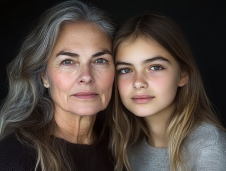 Portrait of a mature woman and a younger woman, both looking confident and beautiful, with their age difference highlighted subtly photo